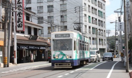 中納言電停を行く7701号（元呉市電の台車、機器を流用）　うしろは吉備団子の廣栄堂