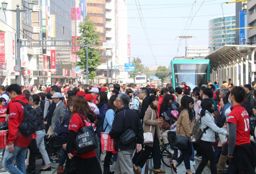 本通りの横断歩道を行く赤い人たち